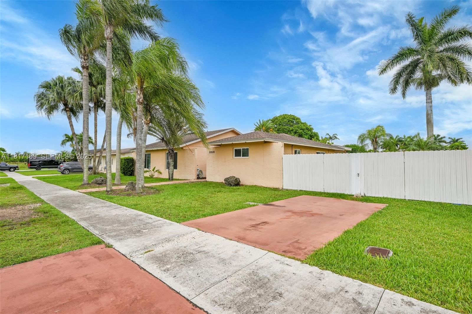 30930 Southwest 190th Avenue Homestead, FL 33030 - Photo 34 of 36 a front view of a house with a yard and garage