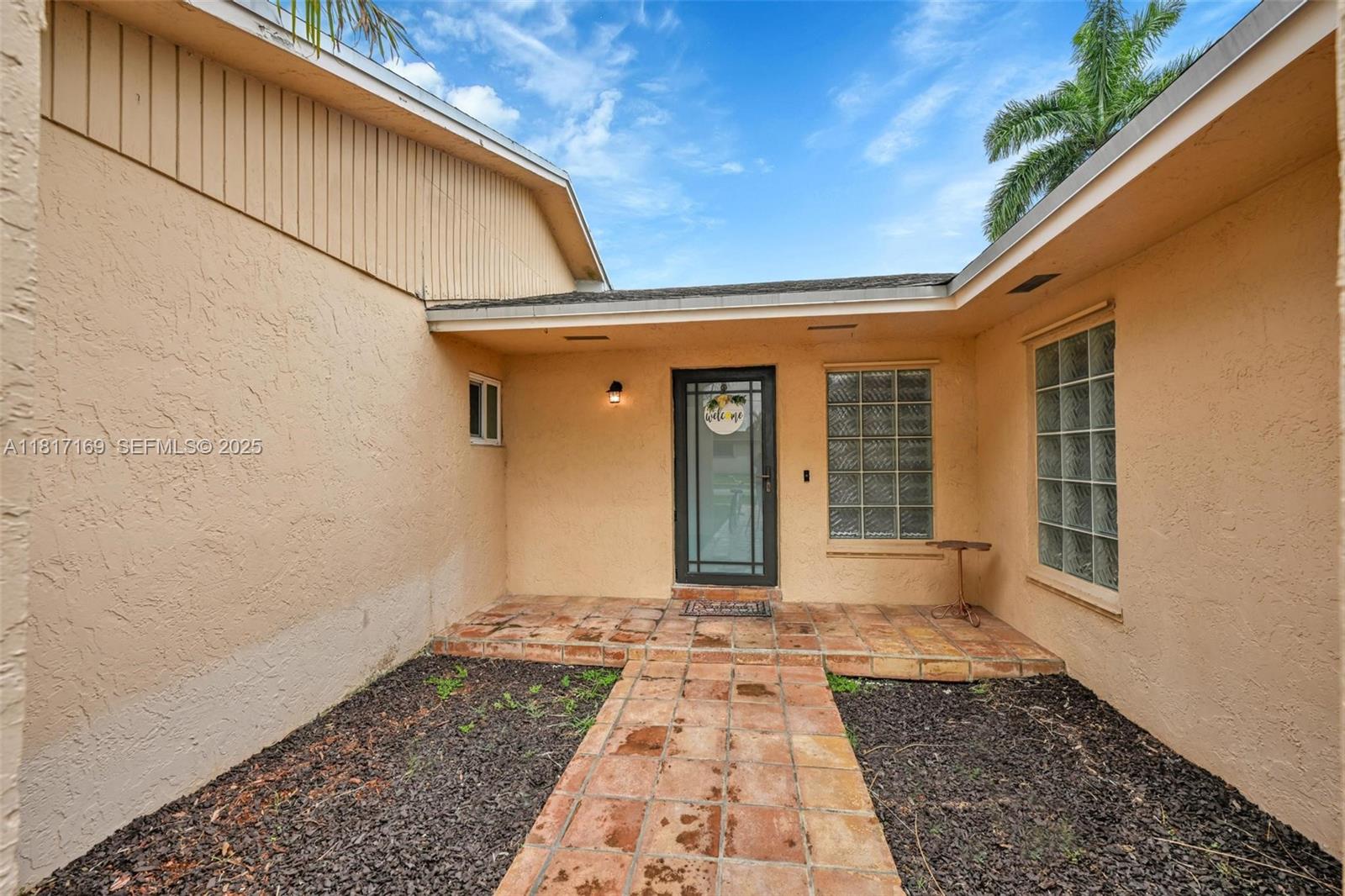 30930 Southwest 190th Avenue Homestead, FL 33030 - Photo 5 of 36 a front view of a house with a yard