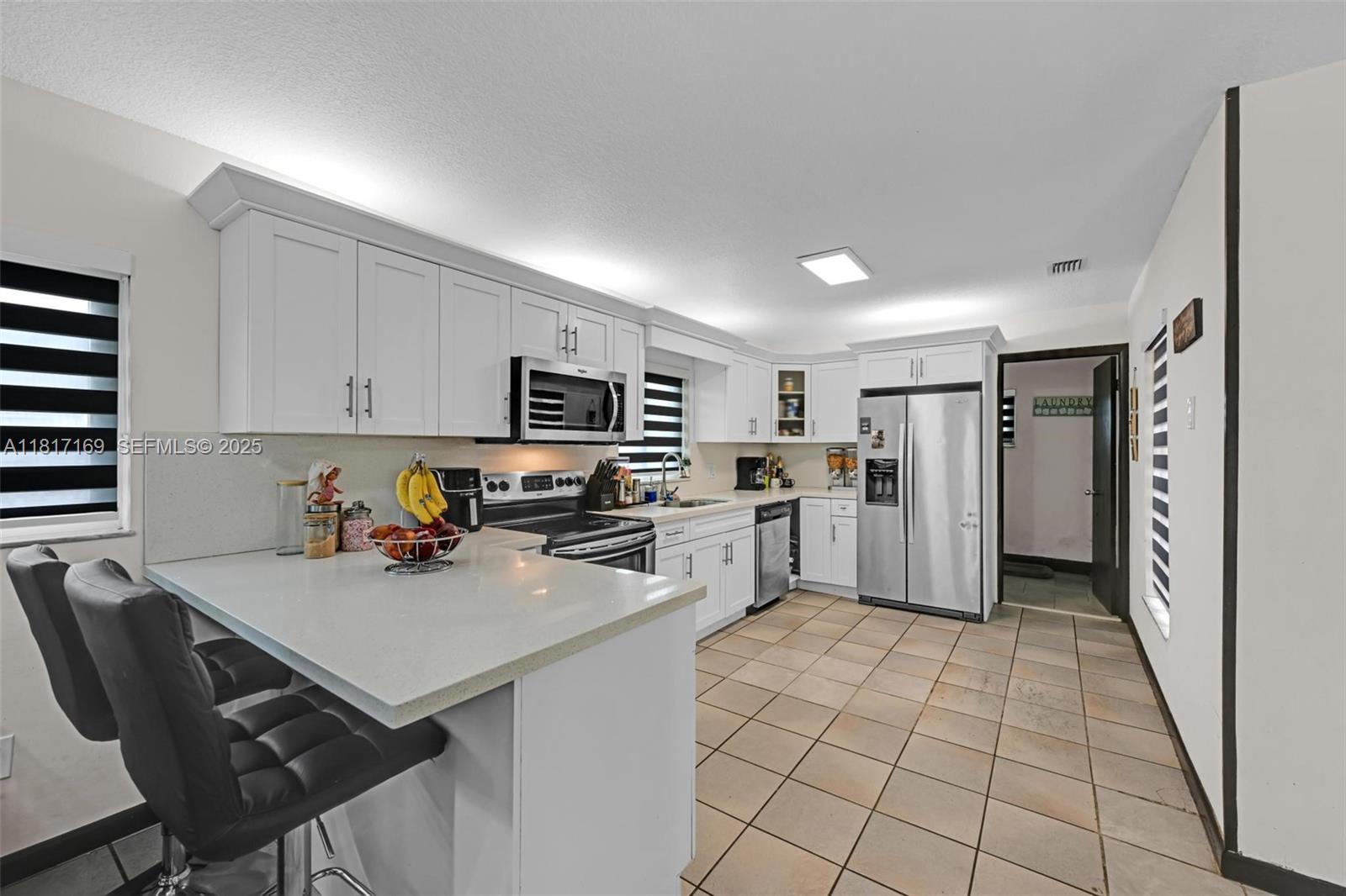 30930 Southwest 190th Avenue Homestead, FL 33030 - Photo 8 of 36 a kitchen with a sink a refrigerator and cabinets