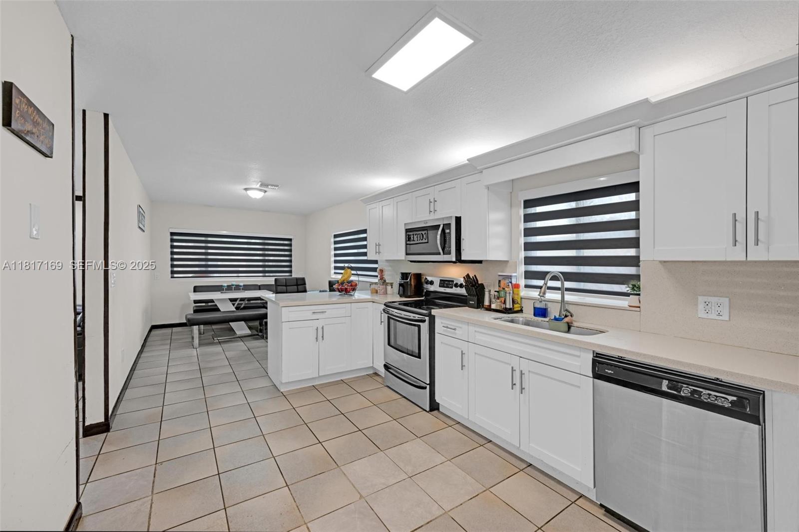 30930 Southwest 190th Avenue Homestead, FL 33030 - Photo 9 of 36 a kitchen with white cabinets and appliances