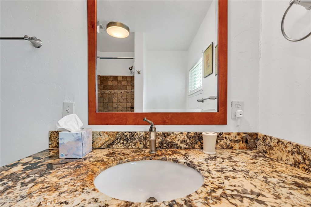 598 East 19th Street Merced, CA 95340 - Photo 15 of 25 a bathroom with a granite countertop sink and a mirror