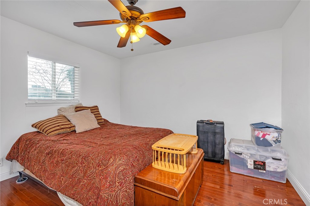 598 East 19th Street Merced, CA 95340 - Photo 16 of 25 a bedroom with a bed and wooden floor