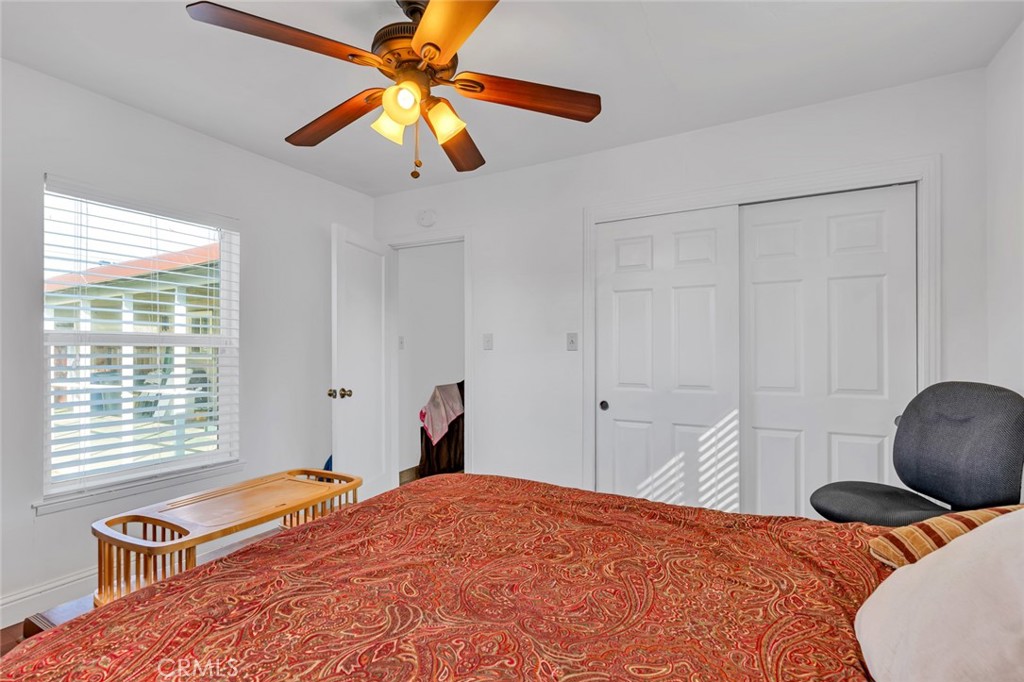 598 East 19th Street Merced, CA 95340 - Photo 17 of 25 a bedroom with a bed and a chandelier