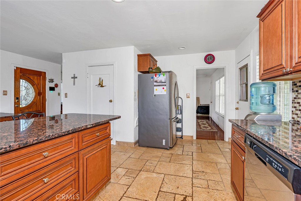 598 East 19th Street Merced, CA 95340 - Photo 22 of 25 a kitchen with stainless steel appliances granite countertop a refrigerator and a stove