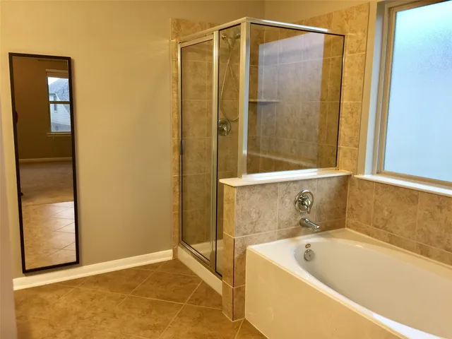 a bathroom with a tub and shower