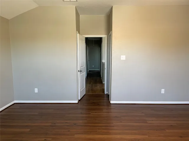 a view of a room with wooden floor and closet