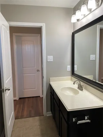 a bathroom with a sink vanity and a mirror