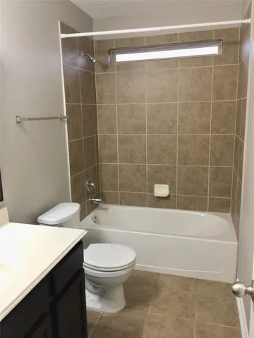 a bathroom with a toilet a sink and shower