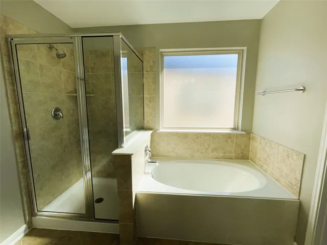 a bathroom with a bathtub sink and mirror
