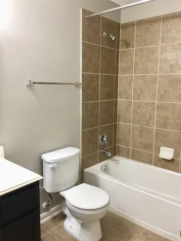 a bathroom with a toilet and a bath tub