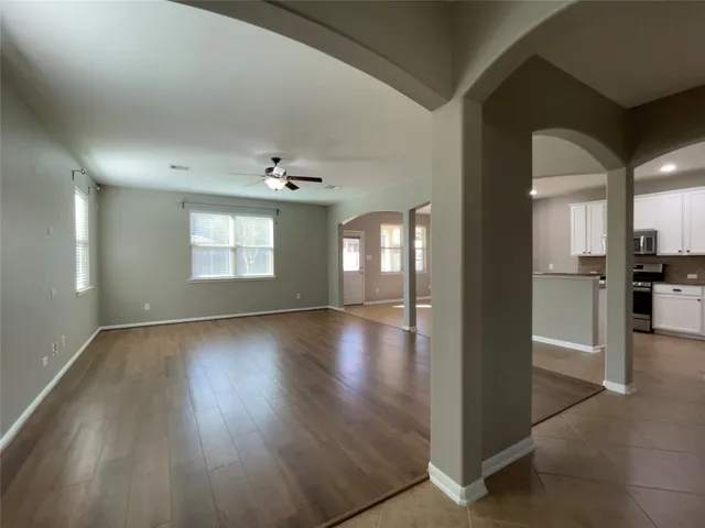 an empty room with wooden floor and entryway