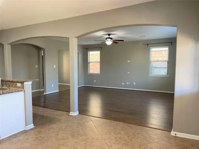 a kitchen with granite countertop white cabinets and stainless steel appliances