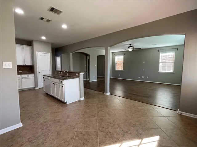 a view of kitchen with cabinets and wooden floor