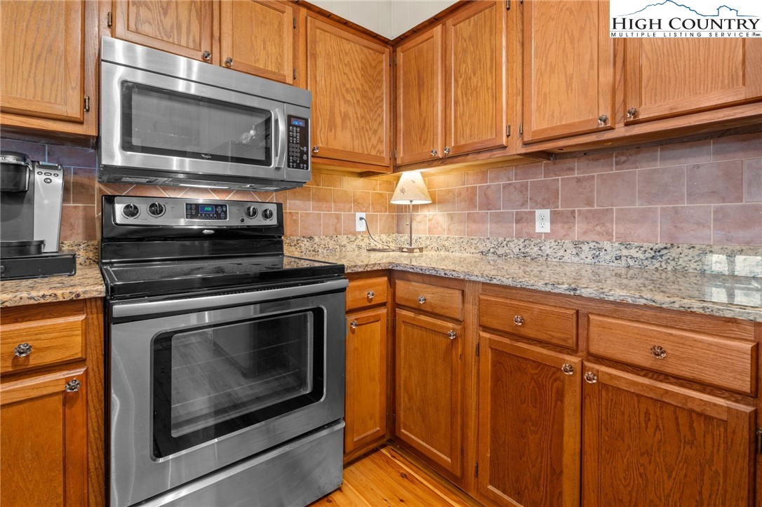 301 Pinnacle Inn Road, Unit 3219 Beech Mountain, NC 28604 - Photo 7 of 30 a kitchen with granite countertop cabinets stainless steel appliances and a sink