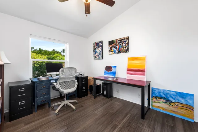 a view of a workspace with furniture and a window
