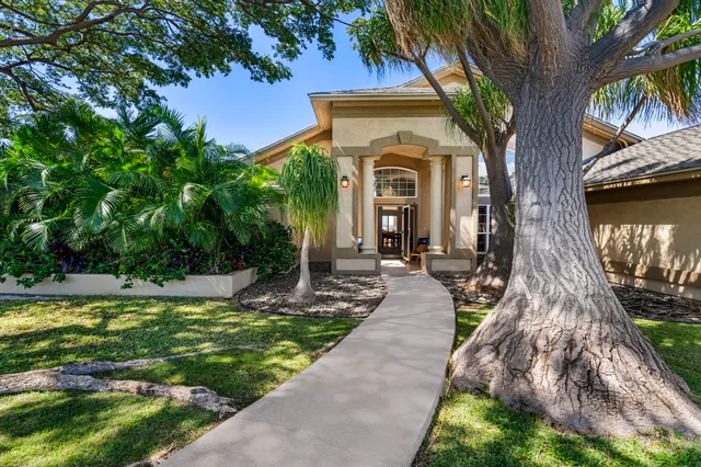 a front view of a house with garden
