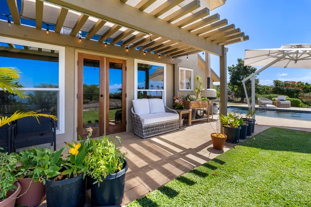 a building outdoor space with patio furniture and potted plants