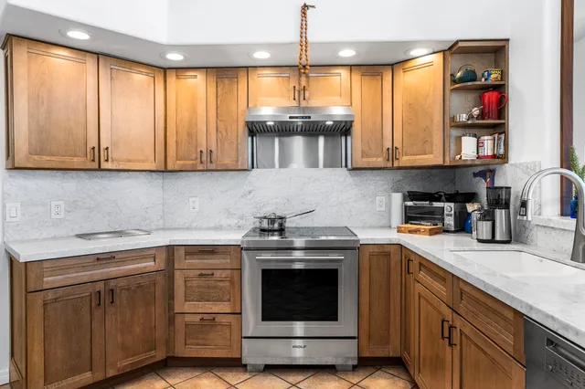 a kitchen with cabinets appliances and a sink