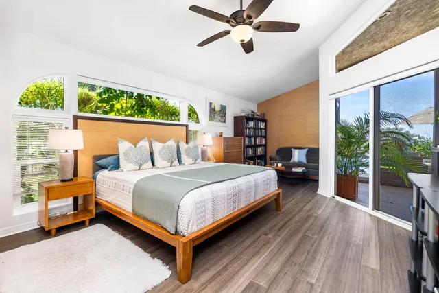 a bedroom with a bed and large window