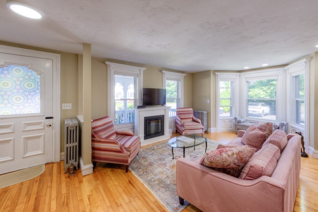167 Worcester Street Grafton, MA 01536 - Photo 12 of 42 a living room with furniture a fireplace and a flat screen tv