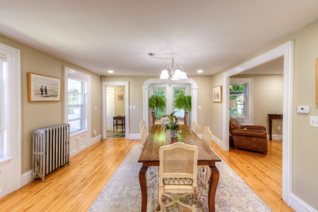 167 Worcester Street Grafton, MA 01536 - Photo 16 of 42 a view of a dining room with furniture a chandelier and wooden floor