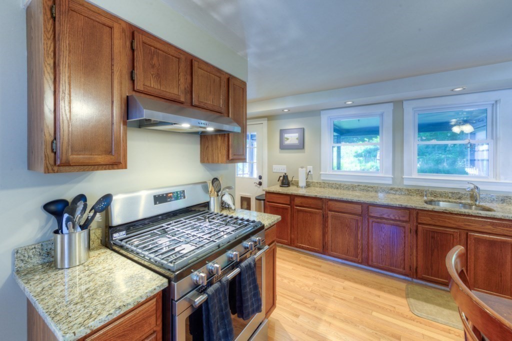 167 Worcester Street Grafton, MA 01536 - Photo 28 of 42 a kitchen with a stove and a wooden cabinets
