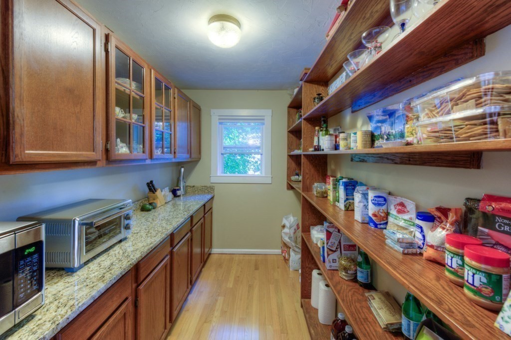 167 Worcester Street Grafton, MA 01536 - Photo 30 of 42 a kitchen with lots of clutter and cabinets