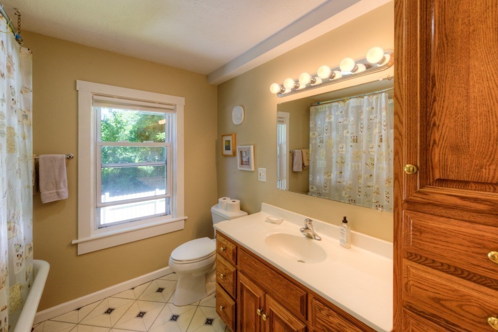 167 Worcester Street Grafton, MA 01536 - Photo 32 of 42 a bathroom with a sink and a large mirror