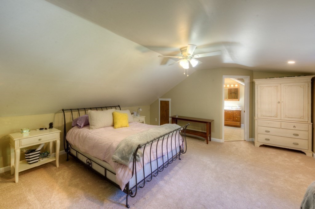 167 Worcester Street Grafton, MA 01536 - Photo 33 of 42 a bedroom with a bed and a chandelier