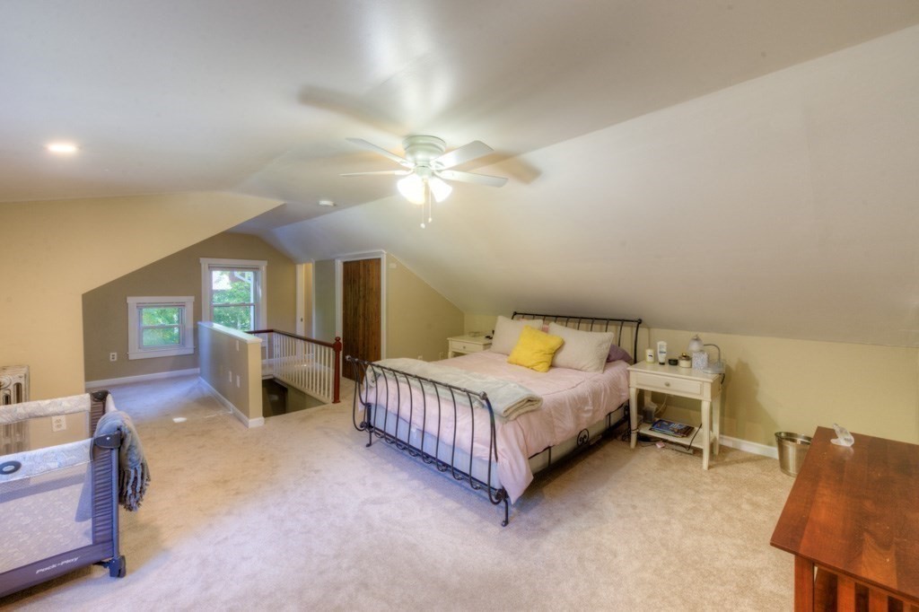 167 Worcester Street Grafton, MA 01536 - Photo 34 of 42 a bedroom with a bed a chandelier and dresser