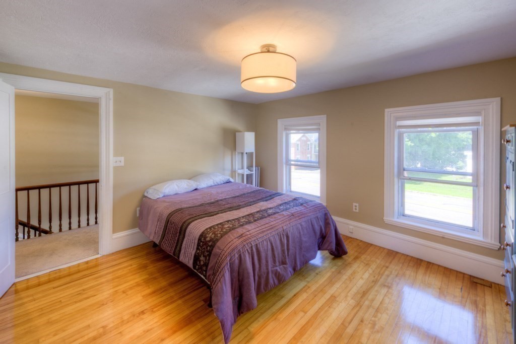 167 Worcester Street Grafton, MA 01536 - Photo 36 of 42 a spacious bedroom with a bed and a window