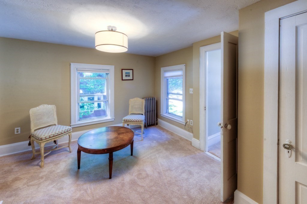 167 Worcester Street Grafton, MA 01536 - Photo 39 of 42 a living room with furniture a window and a chandelier