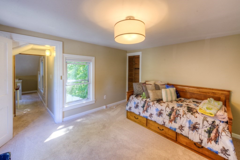 167 Worcester Street Grafton, MA 01536 - Photo 41 of 42 a bed sitting in a bedroom next to a window