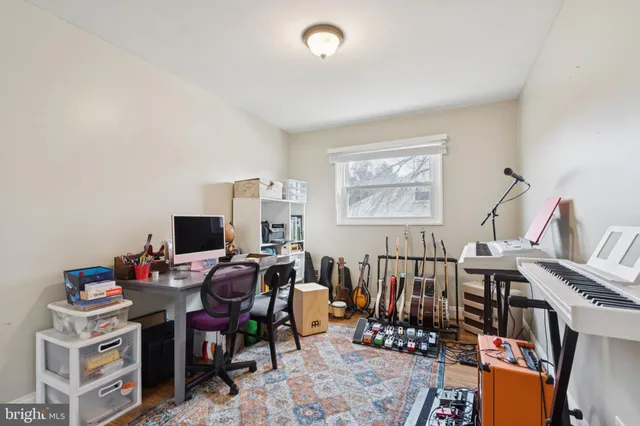 a view of a workspace with furniture and a window