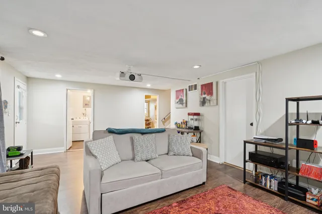 a living room with furniture and a book shelf