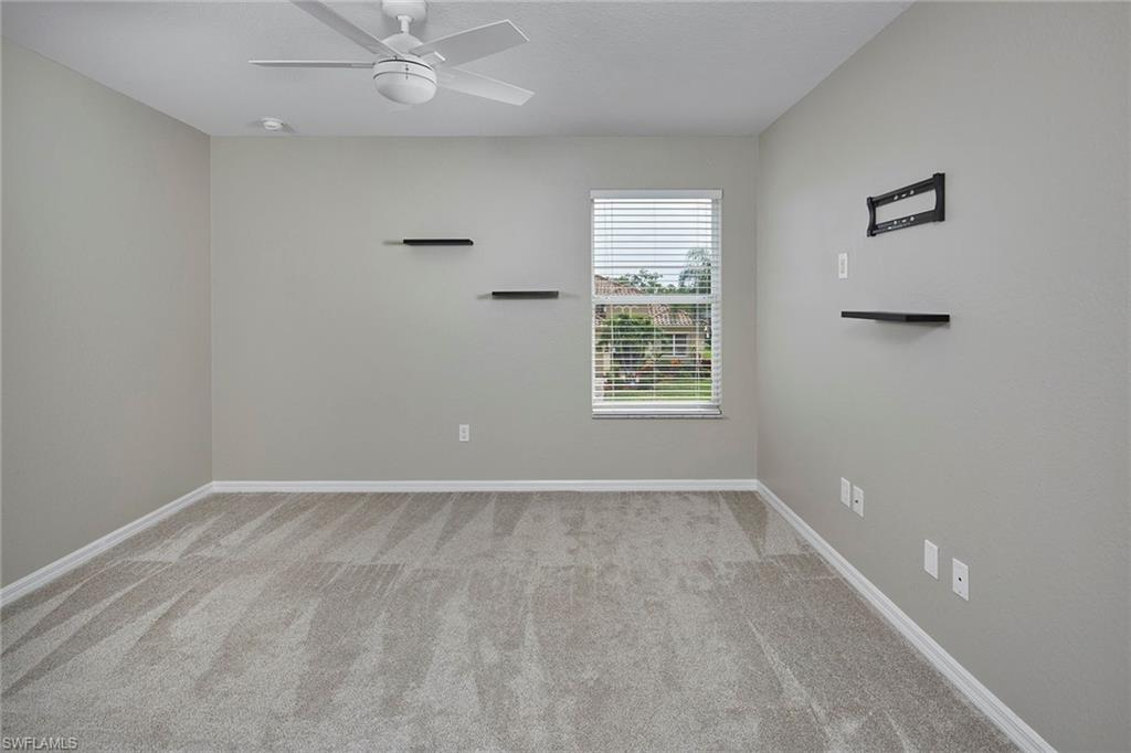21651 Bella Terra Boulevard Estero, FL 33928 - Photo 26 of 40 an empty room with windows and fan