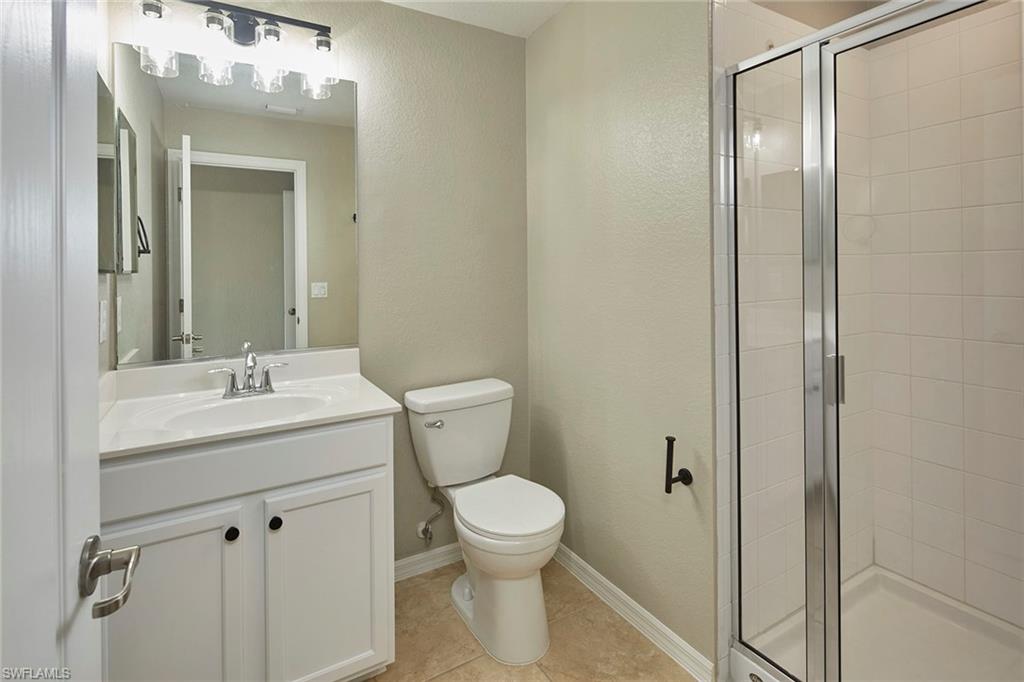 21651 Bella Terra Boulevard Estero, FL 33928 - Photo 27 of 40 a bathroom with a toilet a sink and mirror