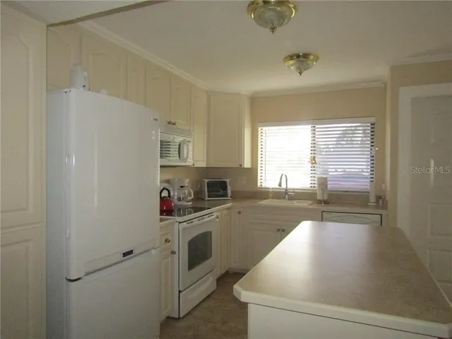 a kitchen with stainless steel appliances a white cabinets and a sink