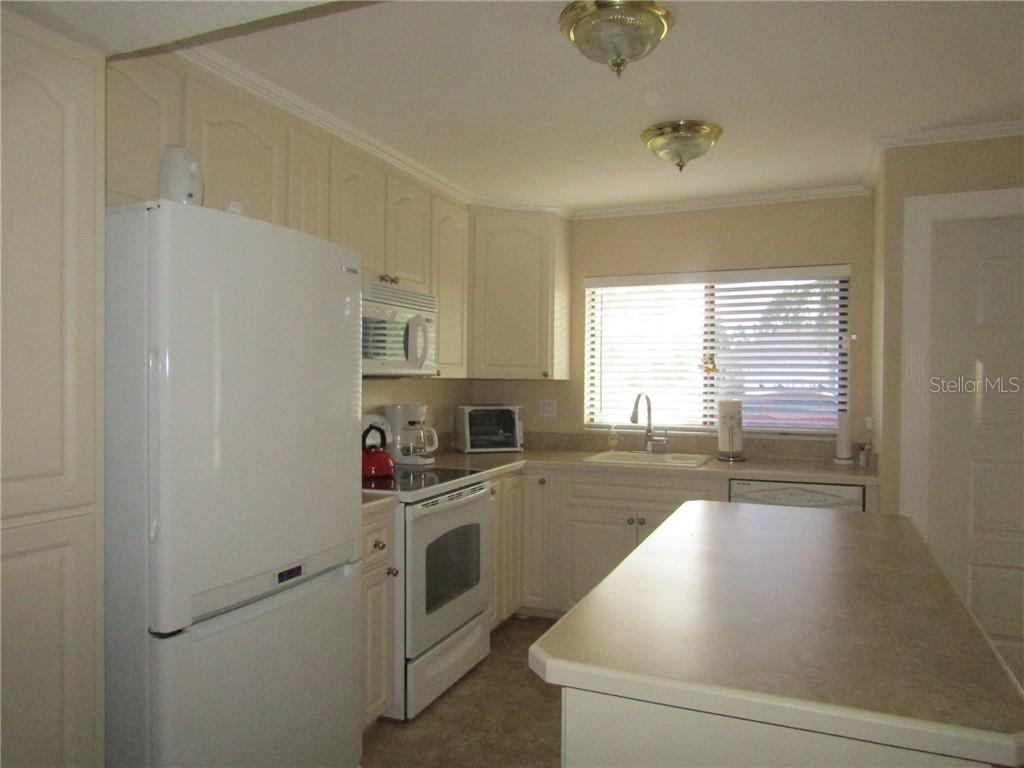 1211 Saxony Circle, Unit A1 Punta Gorda, FL 33983 - Photo 3 of 13 a kitchen with stainless steel appliances a white cabinets and a sink