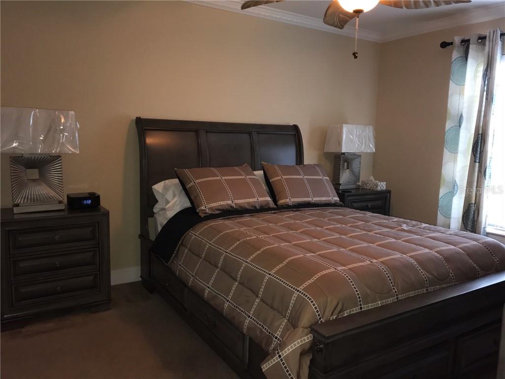 1211 Saxony Circle, Unit A1 Punta Gorda, FL 33983 - Photo 4 of 13 a bedroom with a bed and wooden floor