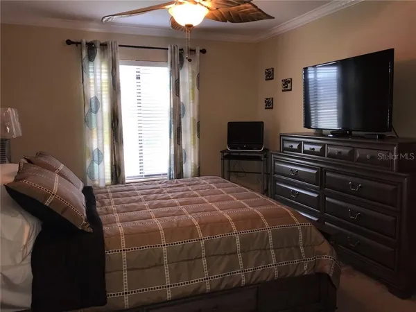a bedroom with a bed and a flat screen tv