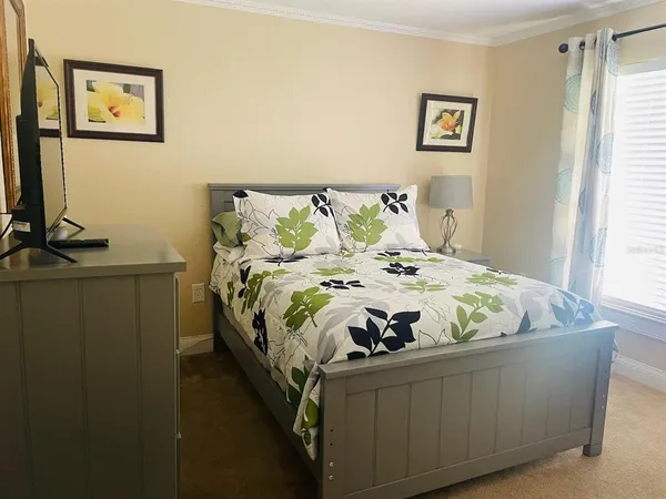 a bed sitting in a bedroom next to a window