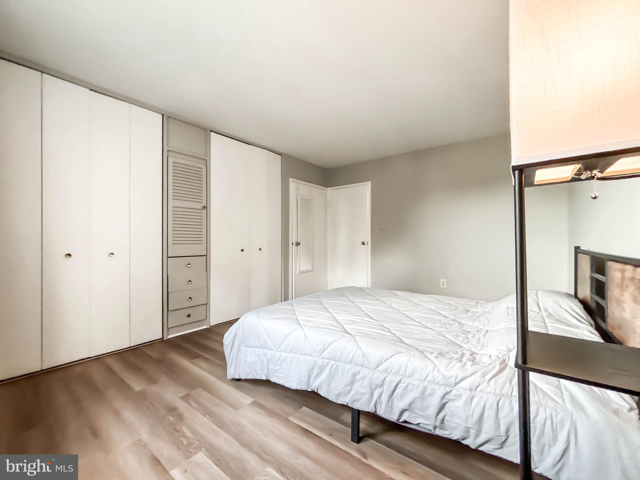 130 Slade Avenue, Unit 414 Baltimore, MD 21208 - Photo 18 of 48 a bedroom with a bed and a flat screen tv