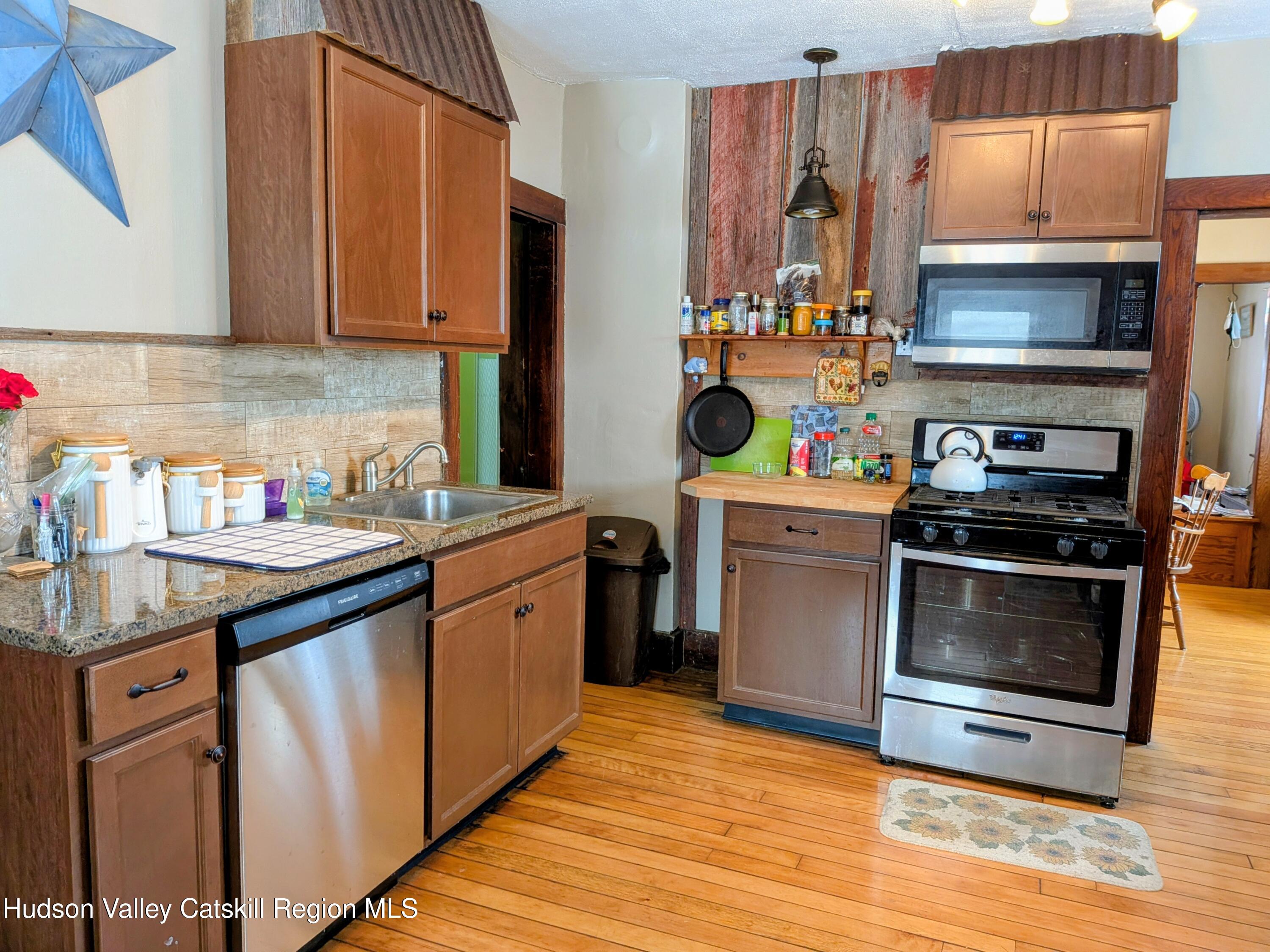 351 Presbyterian Hill Road Stephentown, NY 12168 - Photo 12 of 46 a kitchen with stainless steel appliances a stove a refrigerator and a sink