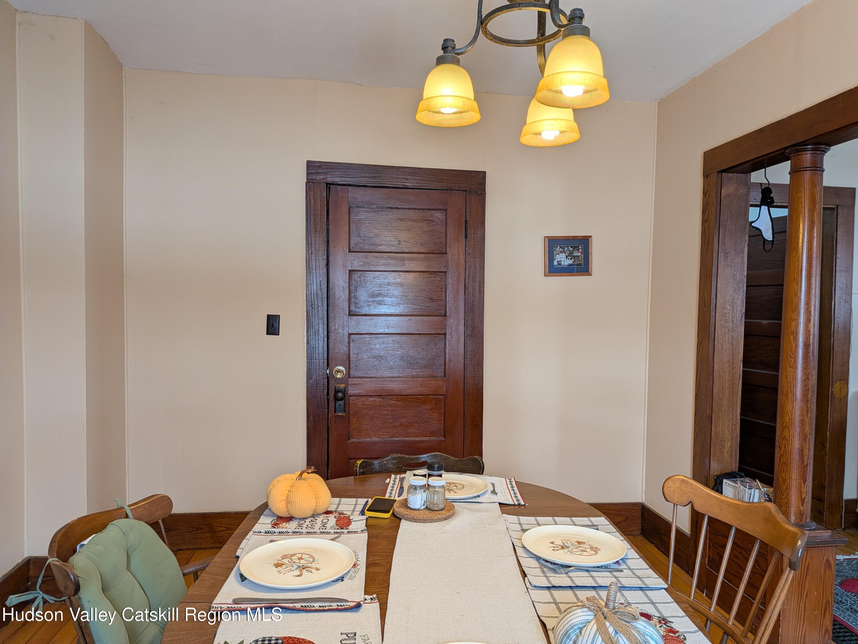 351 Presbyterian Hill Road Stephentown, NY 12168 - Photo 15 of 46 a view of a dining room with furniture and chandelier