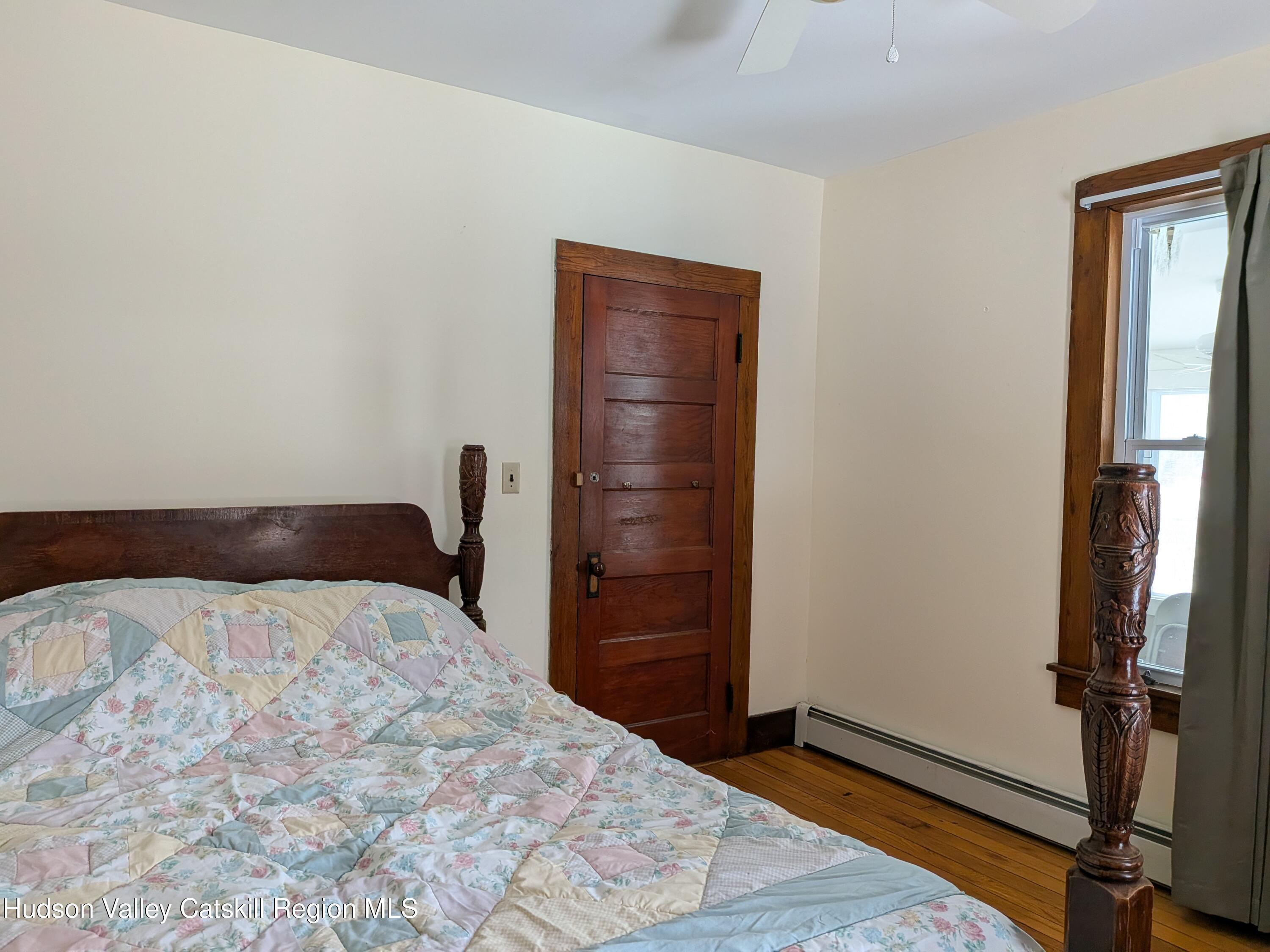 351 Presbyterian Hill Road Stephentown, NY 12168 - Photo 20 of 46 a bedroom with a bed and wooden floor