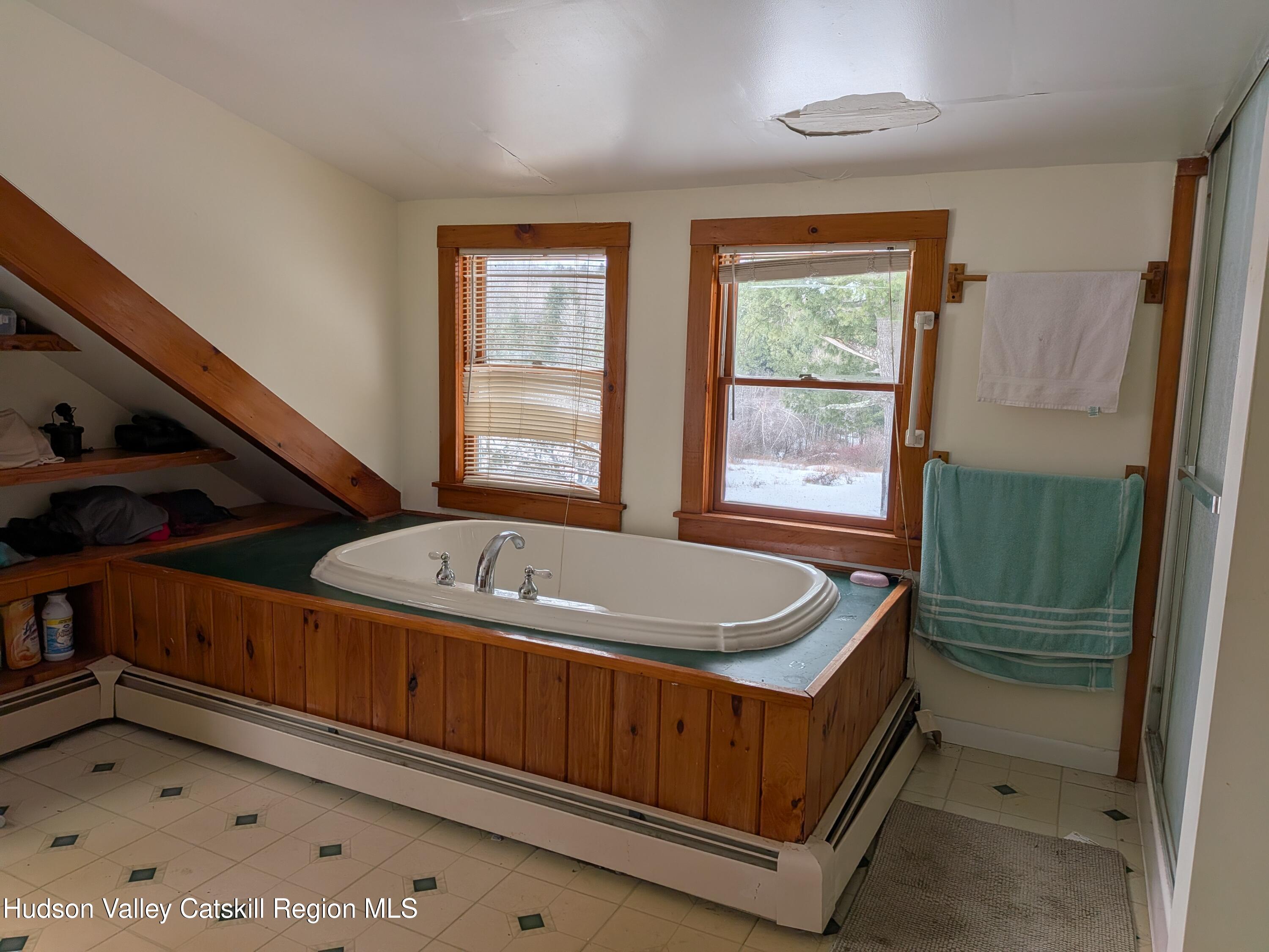 351 Presbyterian Hill Road Stephentown, NY 12168 - Photo 26 of 46 a bathroom with a tub a sink and a window