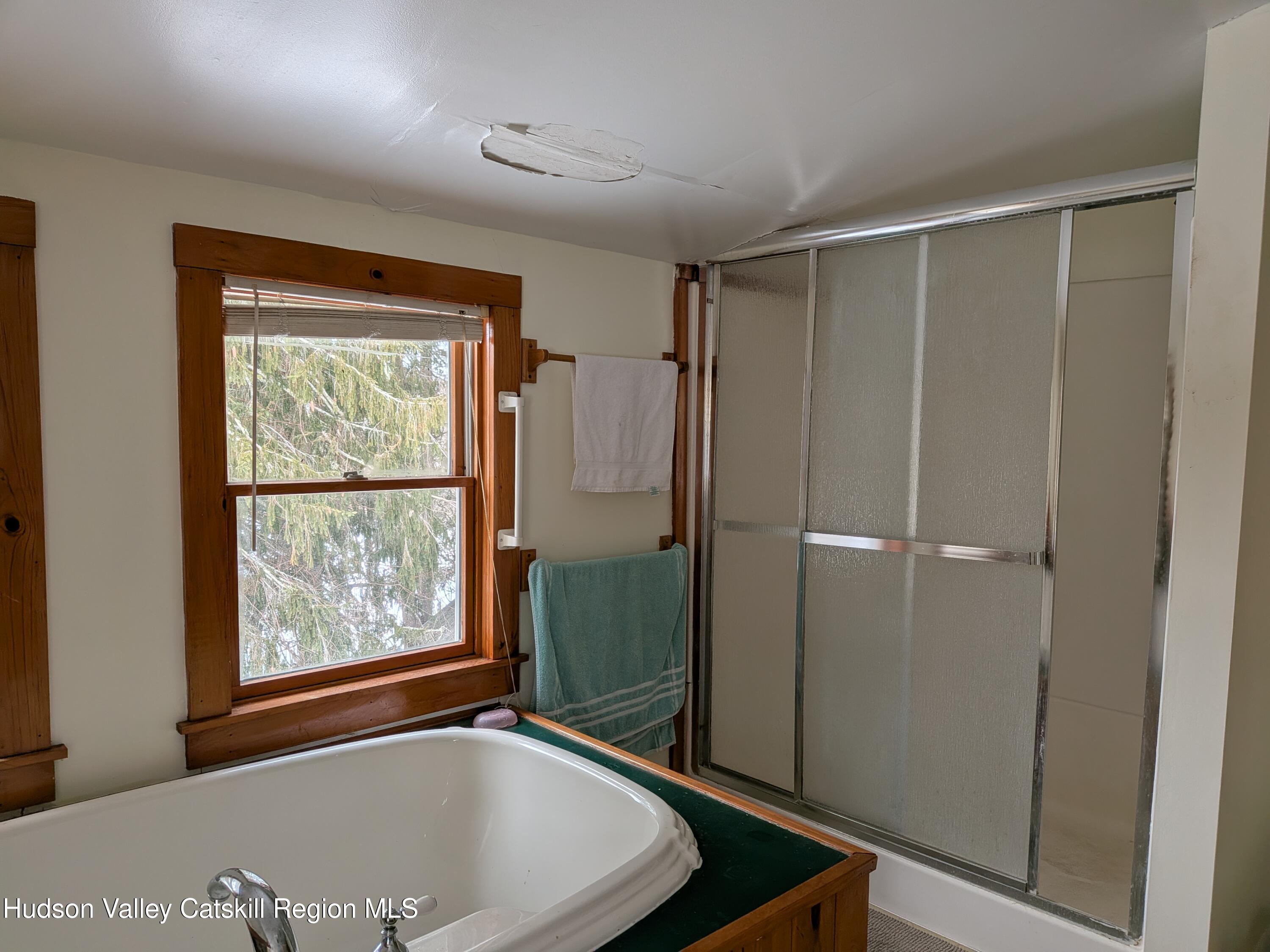 351 Presbyterian Hill Road Stephentown, NY 12168 - Photo 27 of 46 a view of a bathroom with tub and window