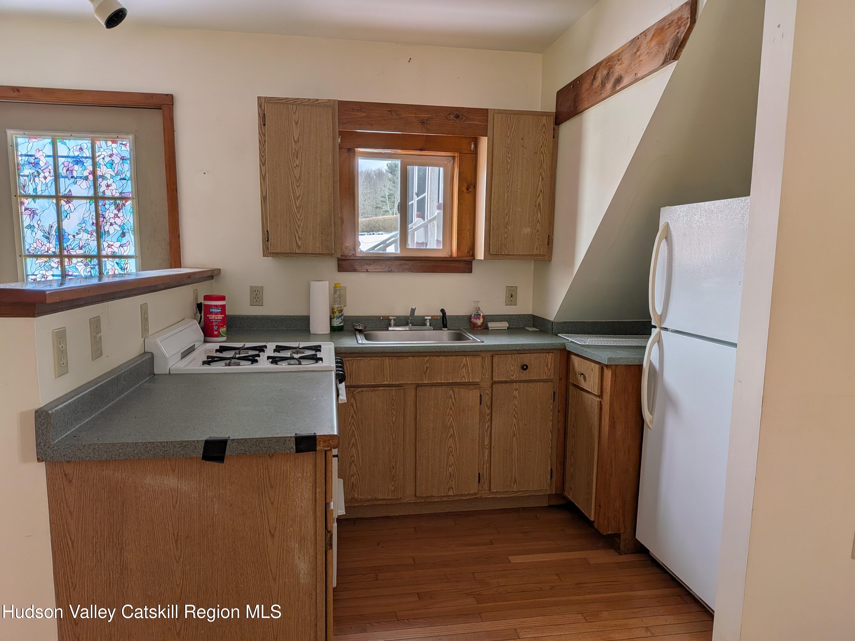 351 Presbyterian Hill Road Stephentown, NY 12168 - Photo 33 of 46 a kitchen with sink cabinets and window