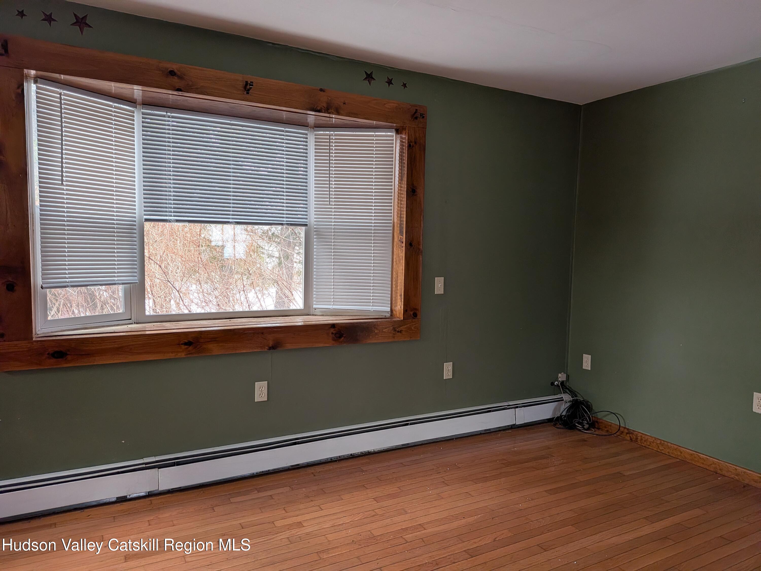 351 Presbyterian Hill Road Stephentown, NY 12168 - Photo 35 of 46 a view of an empty room with wooden floor and a window